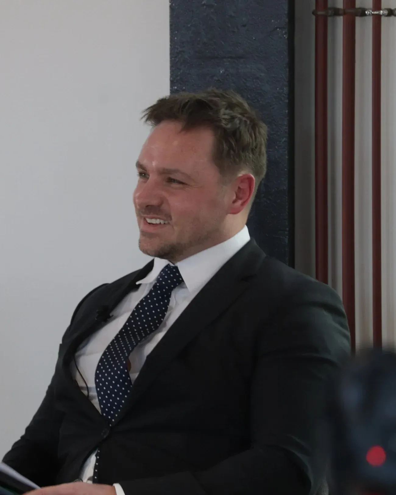Dr Lewis Haydon laughing on the panel at a Dragons’ Den-style pitch event in Birmingham, UK