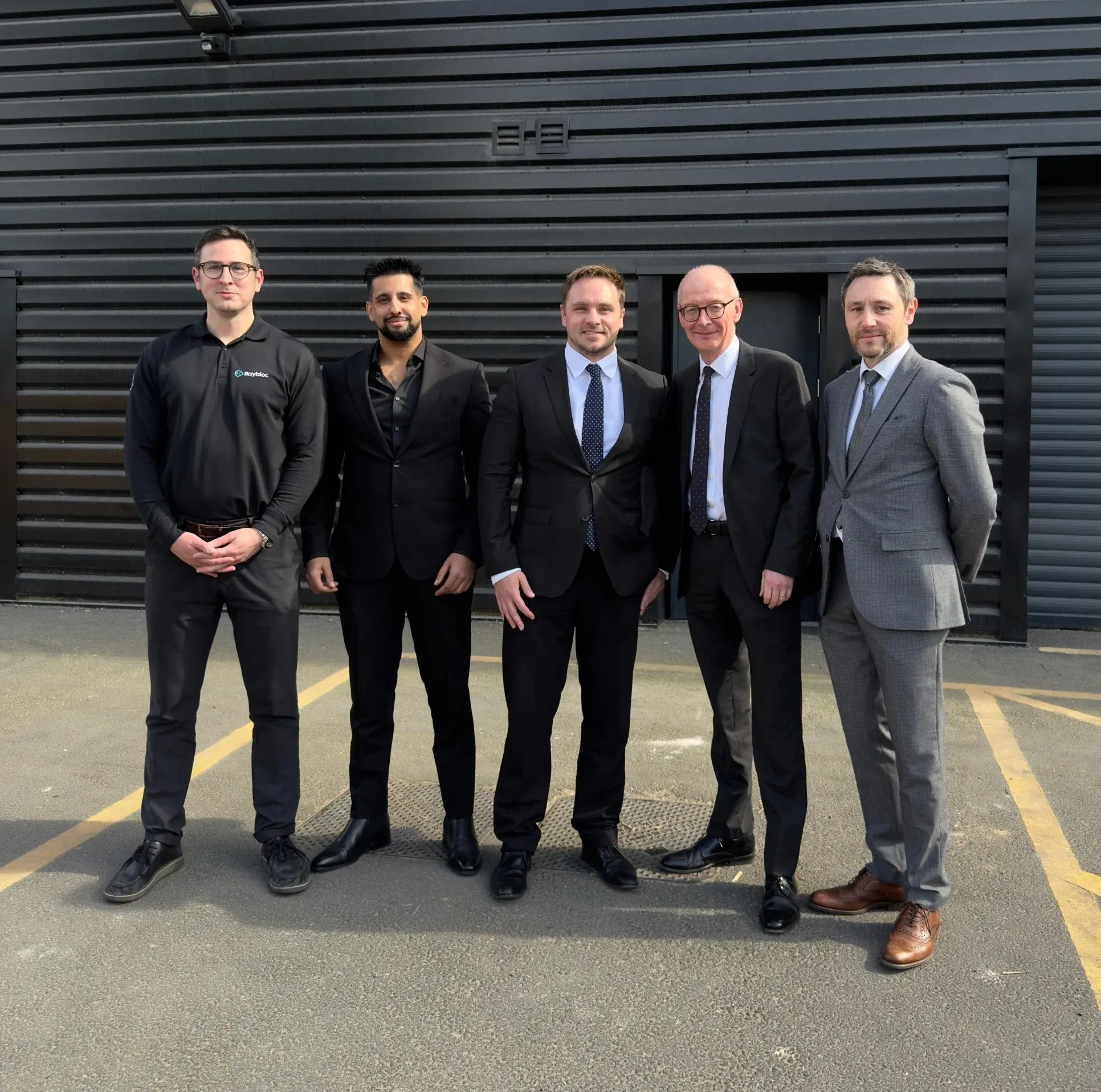 Dr Lewis Haydon (centre) with a business team in the West Midlands, UK